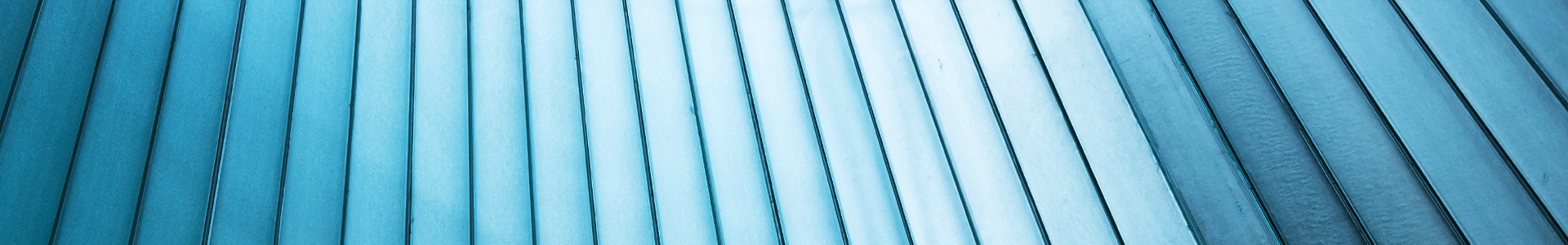 Abstract architectural detail of modern building panels with blue tones and linear texture.
