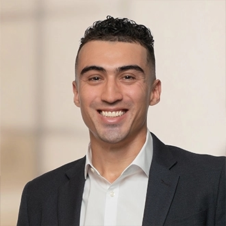 Professional headshot of Adam Garcia