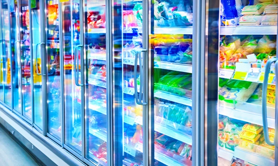 Commercial sized freezer filled with frozen foods.