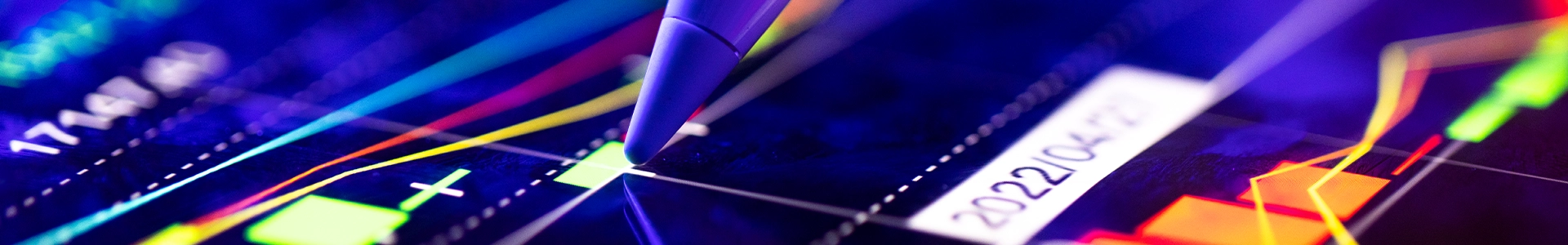 Close‑up of colorful financial charts and trend lines on a digital trading screen with a stylus pointing to data.