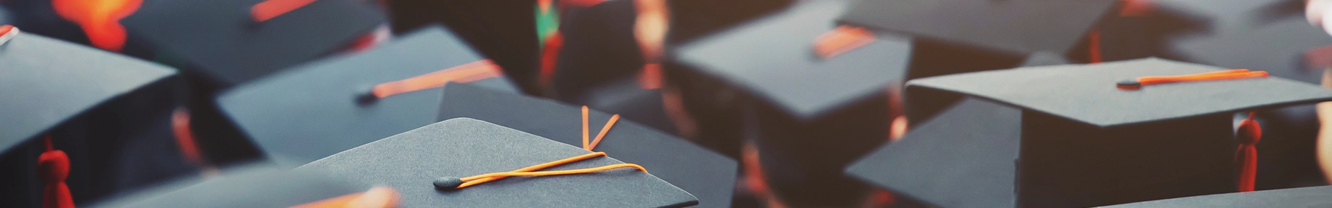 Group of graduation caps with tassels during a commencement ceremony.