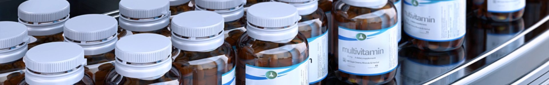 Rows of amber supplement bottles with white caps arranged on a curved metal surface.