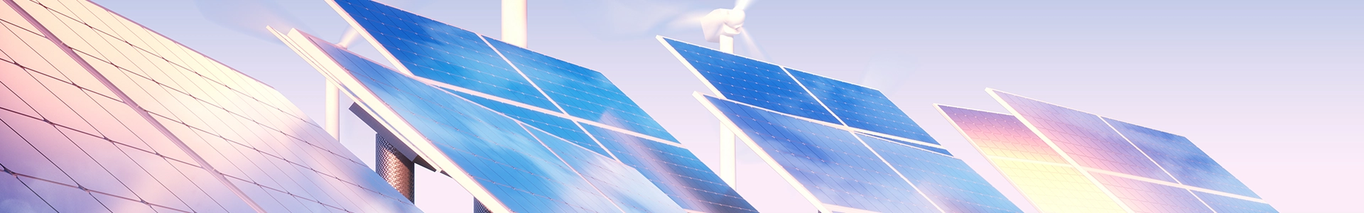 Solar panels installed with wind turbines operating in the background under a bright sky.