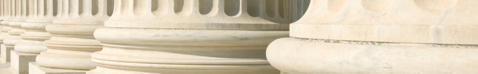 Close-up view of large classical stone columns with detailed bases.